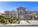 Elegant two-story home with well-manicured landscaping and a spacious two-car garage at 631 Coriander Canyon Ct, Las Vegas, NV 89138