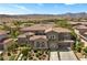 Stunning two-story home with desert landscaping, a three-car garage, and mountain views at 631 Coriander Canyon Ct, Las Vegas, NV 89138