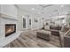 Inviting living room features a cozy fireplace, wood floors, and views into the kitchen at 631 Coriander Canyon Ct, Las Vegas, NV 89138