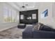 Comfortable living room with a cozy couch, large windows, and modern lighting at 631 Coriander Canyon Ct, Las Vegas, NV 89138
