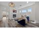 Cozy living room featuring a fireplace, modern lighting, and ample natural light at 631 Coriander Canyon Ct, Las Vegas, NV 89138