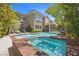 Resort-style pool with a hot tub and lounge chairs, perfect for relaxing and enjoying the outdoors at 631 Coriander Canyon Ct, Las Vegas, NV 89138