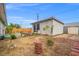 Large backyard with ample space, back house, and decorative stone walkway at 6508 Bourbon Way, Las Vegas, NV 89107