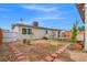 Backyard featuring a stone walkway, green accents, and a bright blue sky at 6508 Bourbon Way, Las Vegas, NV 89107