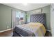 Bedroom features a plush, upholstered headboard and natural light at 6508 Bourbon Way, Las Vegas, NV 89107