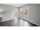 Bright living room with wood-look flooring and backyard access through sliding glass doors at 6508 Bourbon Way, Las Vegas, NV 89107