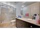 Bathroom featuring a marble shower, dark vanity with marble countertop, and updated sink and fixtures at 6516 Austin Hope Ave, Las Vegas, NV 89118