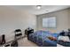 Cozy bedroom featuring a blue patterned bedspread, a window with blinds, and neutral colored carpet at 6516 Austin Hope Ave, Las Vegas, NV 89118