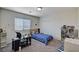 bedroom featuring a single bed, desk, and multiple shelves with books and toys at 6516 Austin Hope Ave, Las Vegas, NV 89118