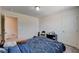 Comfortable bedroom featuring a blue patterned bedspread with a brown teddy bear on it at 6516 Austin Hope Ave, Las Vegas, NV 89118