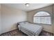 Comfortable bedroom with a large arched window, neutral carpet and a cozy bed at 6516 Austin Hope Ave, Las Vegas, NV 89118