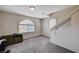 Neutral bonus room features stairs, gray carpet, window, and natural light at 6516 Austin Hope Ave, Las Vegas, NV 89118