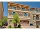 Beautiful home with balcony, arched windows, a two car garage, and green landscaping at 6516 Austin Hope Ave, Las Vegas, NV 89118