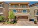 Stunning two-story home with a balcony, arched windows, and a well-manicured front yard at 6516 Austin Hope Ave, Las Vegas, NV 89118