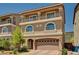 Charming two-story home with a balcony, arched windows, and a brick driveway at 6516 Austin Hope Ave, Las Vegas, NV 89118
