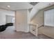 Hallway with carpet, a staircase and a room with a large window and green sofas at 6516 Austin Hope Ave, Las Vegas, NV 89118