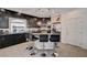 This is a spacious kitchen with a granite countertop island and dark cabinetry at 6516 Austin Hope Ave, Las Vegas, NV 89118