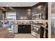 This is a spacious kitchen with a granite countertop, stainless steel appliances, and dark cabinetry at 6516 Austin Hope Ave, Las Vegas, NV 89118