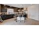 This is a spacious kitchen with a granite countertop island and dark cabinetry at 6516 Austin Hope Ave, Las Vegas, NV 89118