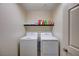 Cozy laundry room with stacked washer and dryer and storage shelf at 6516 Austin Hope Ave, Las Vegas, NV 89118