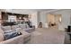 Expansive living area with plush seating, carpet, and open access to the kitchen at 6516 Austin Hope Ave, Las Vegas, NV 89118