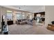 Open-concept living area with plush carpet, large windows, and comfortable seating at 6516 Austin Hope Ave, Las Vegas, NV 89118
