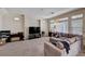 Bright and airy living room featuring plush carpeting, a large TV, and comfortable furniture at 6516 Austin Hope Ave, Las Vegas, NV 89118