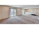 Large open loft space with plush carpets and dual access points to an outdoor balcony at 6516 Austin Hope Ave, Las Vegas, NV 89118