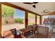 Covered outdoor patio featuring a ceiling fan, brick privacy wall, and a wooden table with chairs at 6516 Austin Hope Ave, Las Vegas, NV 89118