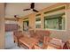 Covered outdoor patio featuring a ceiling fan and a wooden table with chairs at 6516 Austin Hope Ave, Las Vegas, NV 89118