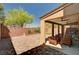 Covered outdoor patio featuring a ceiling fan, brick privacy wall, and a wooden table with chairs at 6516 Austin Hope Ave, Las Vegas, NV 89118
