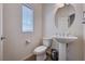 This is a clean powder room with pedestal sink, toilet, and modern fixtures at 6516 Austin Hope Ave, Las Vegas, NV 89118