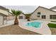 Backyard with small pool, surrounded by gravel and palm trees at 6549 Gazelle Dr, Las Vegas, NV 89108