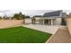 The backyard has artificial turf, a modern shed, a covered patio and solar panels on the roof at 6549 Gazelle Dr, Las Vegas, NV 89108