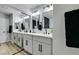A luxurious bathroom featuring a double vanity, mirrors, and modern lighting at 6549 Gazelle Dr, Las Vegas, NV 89108