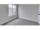 A carpeted bedroom features a large window with bright light, neutral walls, and white trim at 6549 Gazelle Dr, Las Vegas, NV 89108