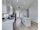 Modern kitchen with white cabinets, stainless steel appliances, and a large island with quartz countertop at 6549 Gazelle Dr, Las Vegas, NV 89108