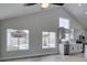 Open living room featuring tile flooring, vaulted ceiling, and views of the pool and modern kitchen at 6549 Gazelle Dr, Las Vegas, NV 89108