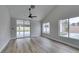 Open living room with vaulted ceilings, a ceiling fan, wood-look tile flooring, and sliding doors to the backyard at 6549 Gazelle Dr, Las Vegas, NV 89108