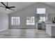 Bright living room with vaulted ceiling, tile flooring, windows overlooking a pool and modern kitchen at 6549 Gazelle Dr, Las Vegas, NV 89108