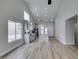 Open floor plan featuring tile flooring, vaulted ceilings, and a view of the modern kitchen at 6549 Gazelle Dr, Las Vegas, NV 89108