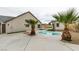 Backyard featuring an in-ground pool, palm trees, a modern shed, and concrete patio at 6549 Gazelle Dr, Las Vegas, NV 89108