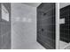 Modern shower featuring black and white tiles and a rainfall shower head at 6549 Gazelle Dr, Las Vegas, NV 89108