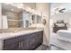 Bathroom with a double vanity, granite countertop, and convenient access to the walk-in shower and bedroom at 6661 Gallup Ct, Pahrump, NV 89060