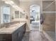 Bathroom showcasing a double vanity, granite countertop, and convenient access to the shower and bedroom at 6661 Gallup Ct, Pahrump, NV 89060