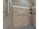 Contemporary walk-in shower with rainfall shower head, mosaic tile accents, and built-in shelving at 6661 Gallup Ct, Pahrump, NV 89060