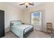 Bright bedroom with black metal bed frame, neutral carpeting, and a large window offering natural light at 6661 Gallup Ct, Pahrump, NV 89060