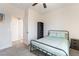 Neutral bedroom with black metal bed frame, neutral carpeting, and an ensuite door at 6661 Gallup Ct, Pahrump, NV 89060