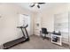 Bedroom featuring a ceiling fan and natural light with a treadmill, desk, shelves, and workspace at 6661 Gallup Ct, Pahrump, NV 89060