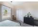 Bright bedroom featuring a neutral color palette, closet with sliding doors, and a large window at 6661 Gallup Ct, Pahrump, NV 89060